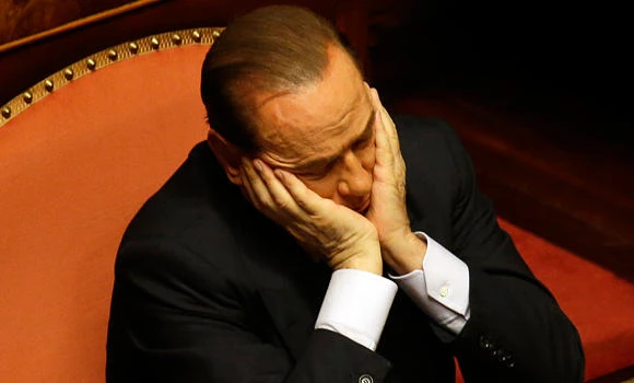Berlusconi defeated, decides to back Italy government