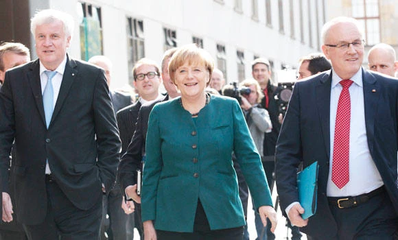 Merkel, defeated rivals discuss possible coalition