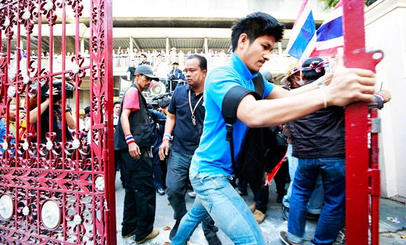 Thai protesters march on, defiant after grenade attack