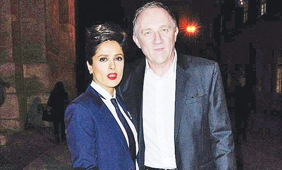 Salma Hayek turns up in YSL menswear in Paris show