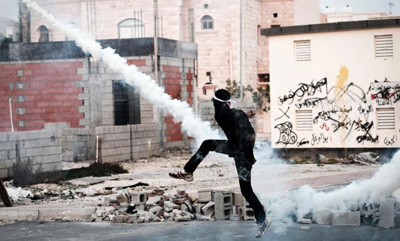 Bahrain upholds jail for 18, lifts travel ban on opposition leader