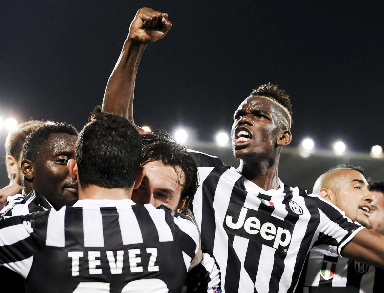 Benfica survives Spurs fright; Juve through