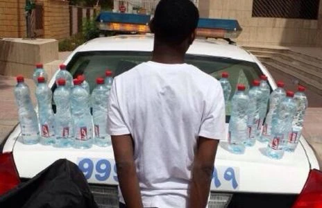 Bootlegger arrested with bottles of liquor for sale
