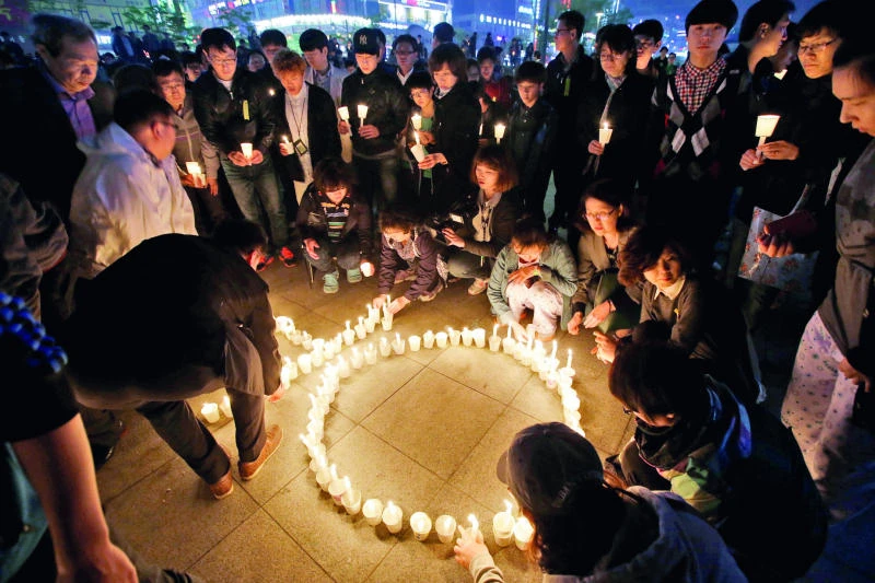 Kin of ferry disaster victims confront S. Korean officials