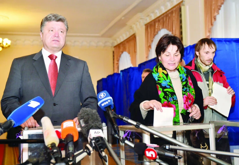 Divided Ukraine votes under shadow of war