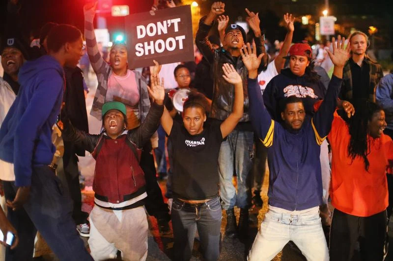 Angry protesters yell at riot police in US