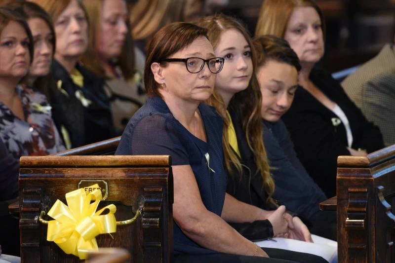 Families of slain UK aid workers call for unity