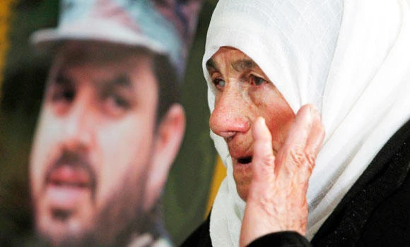 Angry Hezbollah men bury top fighter Jihad Mughniyeh