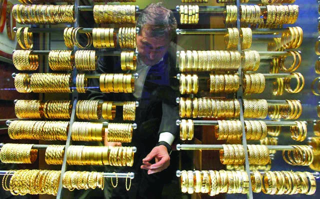 Gold posts biggest monthly gain in three years on haven demand