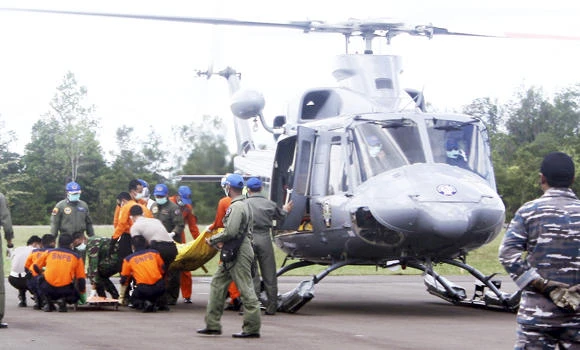 Divers find bodies belted in seats near AirAsia fuselage