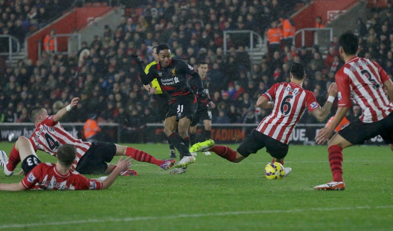 Liverpool survives penalty drama to sink Saints