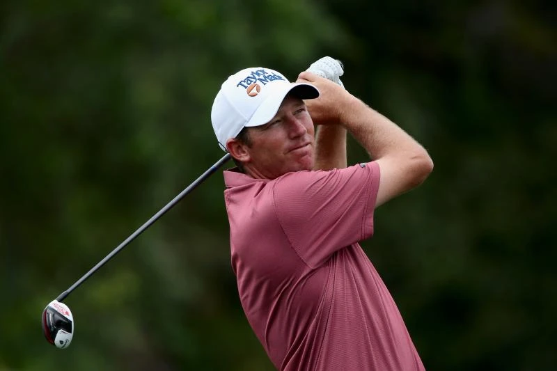 McIlroy struggles in wind, unheralded Herman leads