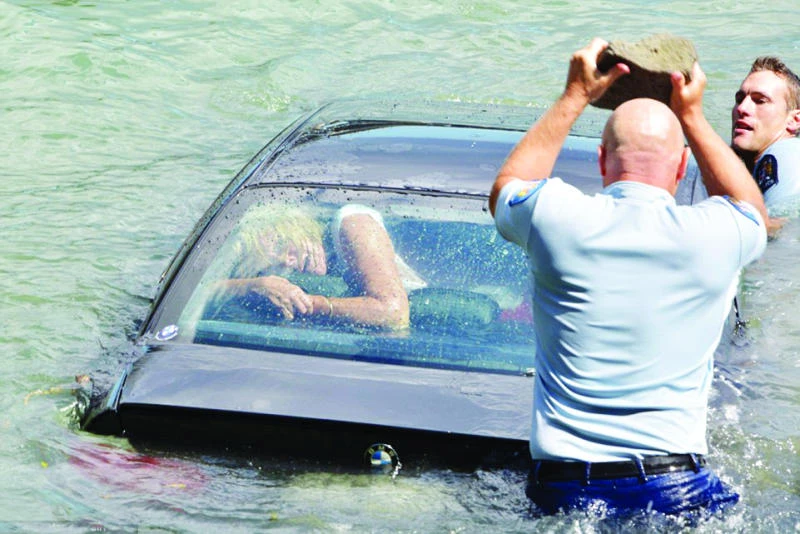 Woman trapped in sinking car rescued