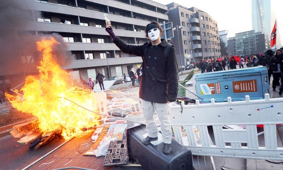 Police cars set alight at austerity protest in Germany