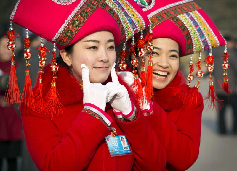 China lowers growth target, promises to open industries