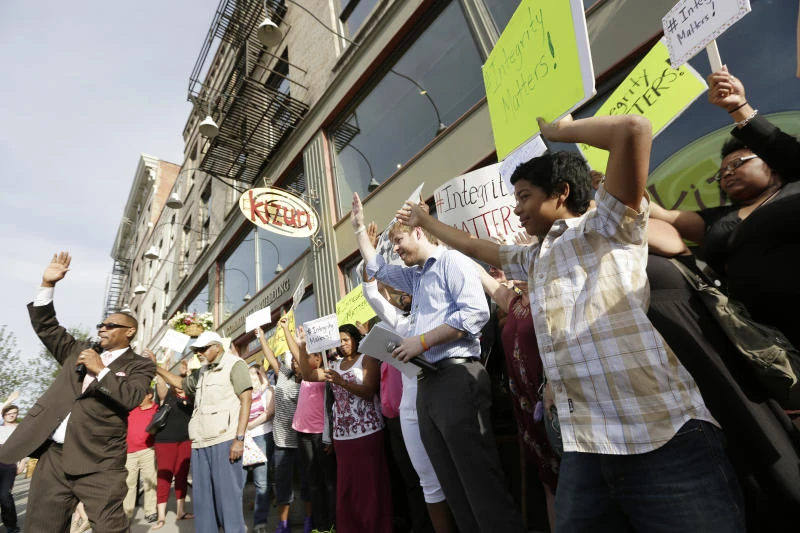 American activist quits amid furor over race