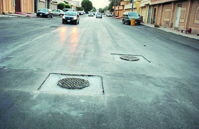 Manhole covers not protected by asphalt a hazard to road users