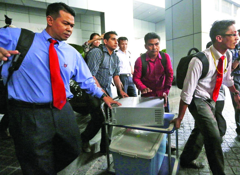 Malaysian officers raid office of fund in probe linked to PM