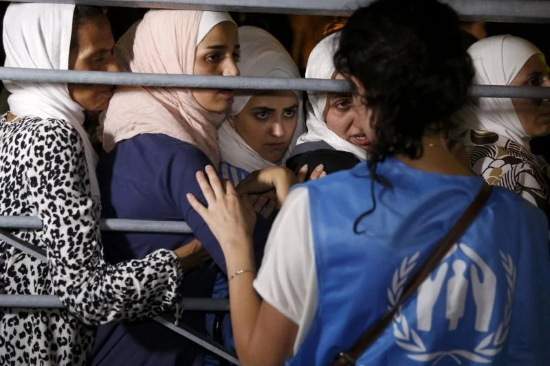 Syrians begin boarding refugee ship on Greek island