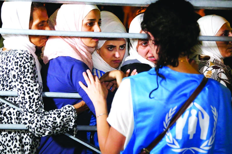 Syrians begin boarding refugee ship on Greek island