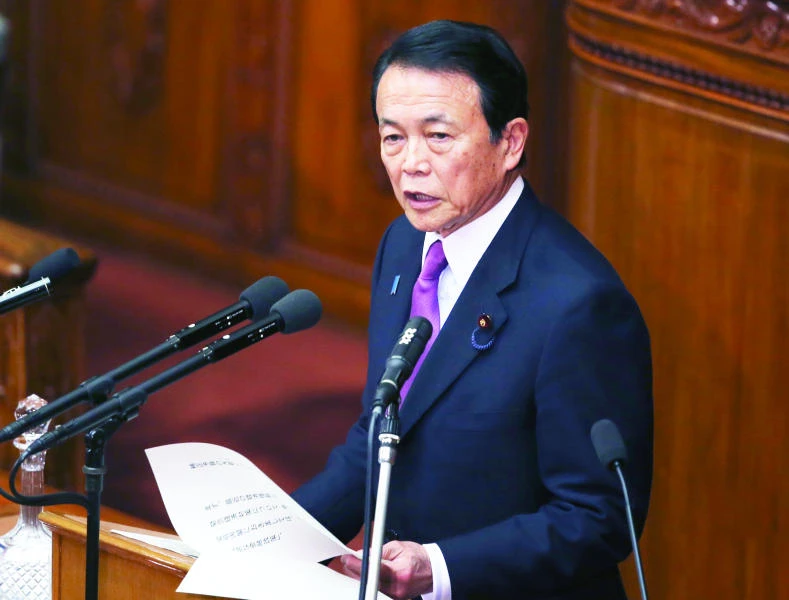 Japan's finance minister warns China on currency moves