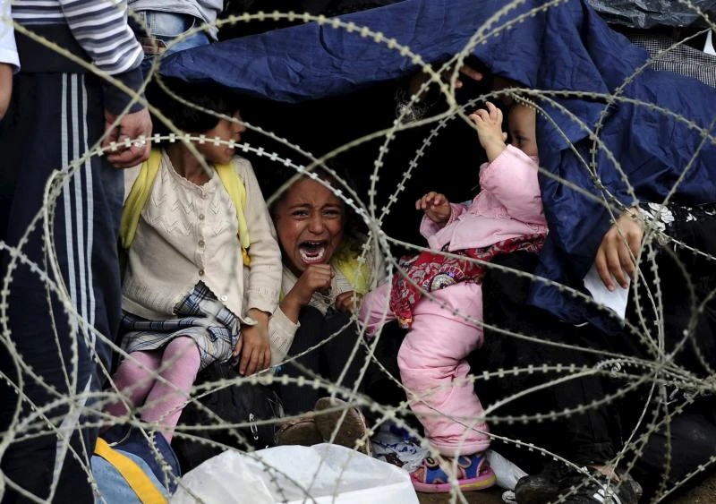 Chaos at Macedonia border as refugees tear through police lines