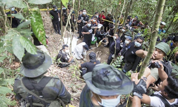 Malaysia finds 24 more bodies of trafficking victims