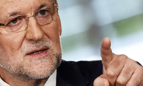 Spain raises salaries ahead of election, warns on Catalonia