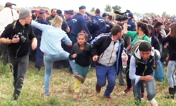 Camerawoman who tripped migrant attacks social media