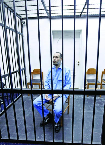 Qaddafi’s son in court over murder, repression