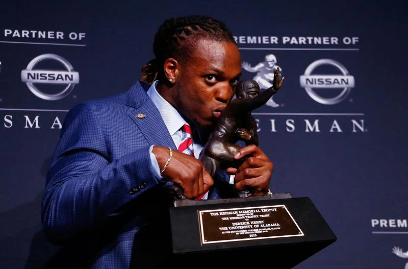 Henry wins close race to claim Heisman Trophy