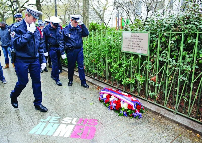A year on, French president honors 17 terror victims