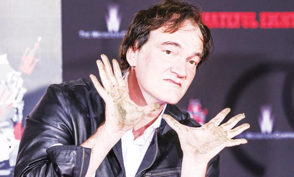 Tarantino shuns rain to leave imprint on Hollywood