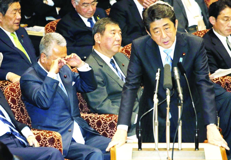 Japan’s economy minister grilled over report he took bribes