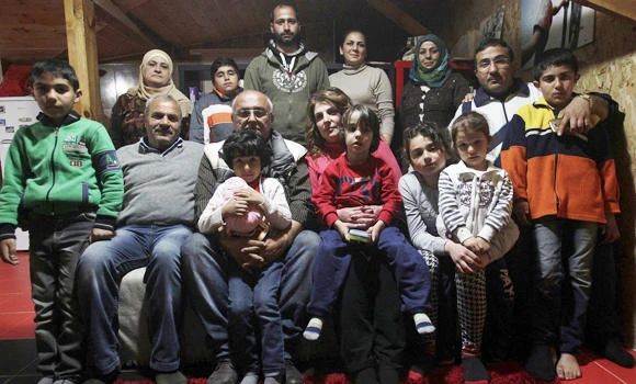 Greek family opens home to 2 Syrian migrant families