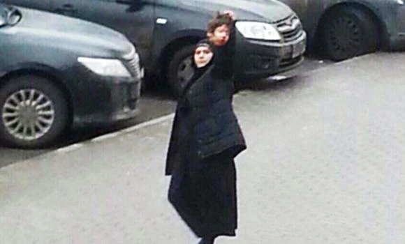 Russian police arrest woman seen waving child’s head