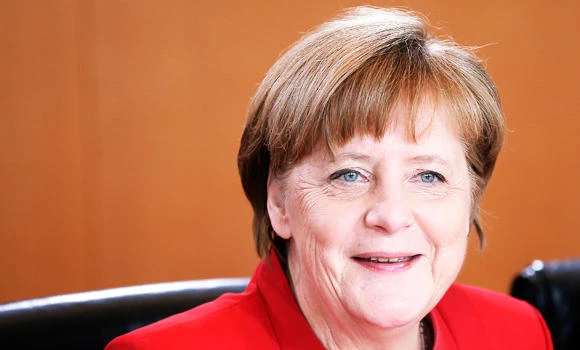 German Chancellor Angela Merkel smiles as she arrives for the weekly cabinet meeting at the Chancellery in Berlin, Germany, on Wednesday. (AP)