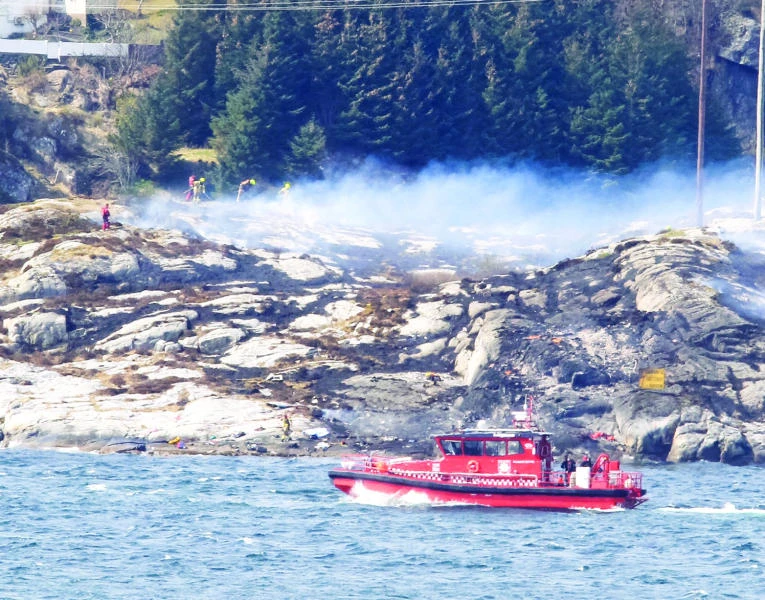 COPTER CRASH: Rescue forces work at the shore west of Bergen, Norway, after a helicopter transporting 13 workers from an offshore oil field in the North Sea crashed off on Friday. (AFP)