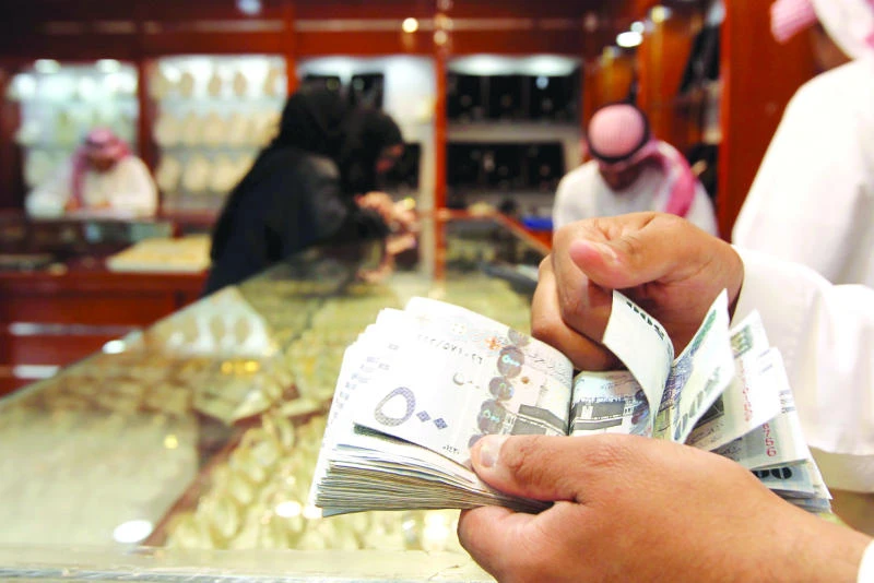 A salesman counts money at a jewelry shop in Riyadh. (Reuters)
