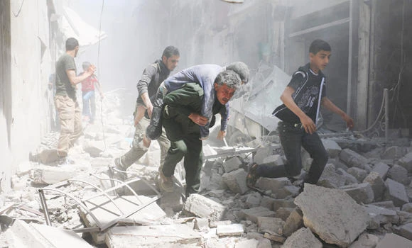 Syrians evacuate an injured man amid the rubble of destroyed buildings following a reported air strike on the rebel-held neighbourhood of Al-Qatarji, in the northern Syrian city of Aleppo, on Friday. (AFP)
