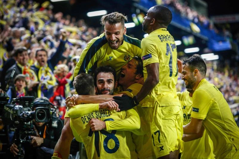 JUBILANT: Villarreal's forward Adrian Lopez, center, celebrates a goal with Villarreal's forward Roberto Soldado, top, and other teammates during the UEFA Europa League semifinal first leg football match at El Madrigal stadium in Vila-real on Thursday. (AFP)