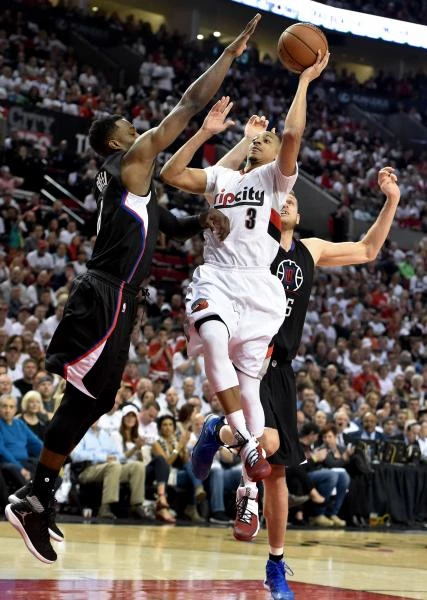 TENSE MOMENT: McCollum (3) of the Portland Trail Blazers drives to the basket on Jeff Green (8) and Cole Aldrich (45) of the Los Angeles Clippers in the fourth quarter of Game Six of the Western Conference Quarterfinals during the NBA Playoffs at the Moda Center in Portland, Oregon, on Friday. (AFP)