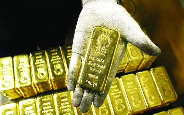 Gold gains on lower dollar after Fed remains cautious on rates