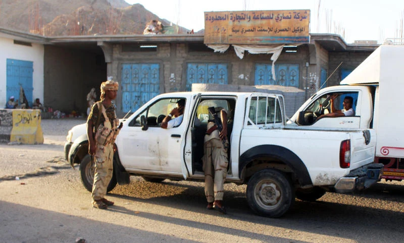 Yemeni troops search a vehicle at a checkpoint following suicide attacks in the southeastern Yemeni port of Mukalla on Thursday. (AFP)