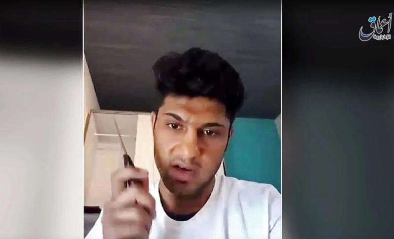 This still image taken from an undated Daesh video purports to show a 17-year-old Afghan asylum-seeker who attacked people with an ax and knife on a train in southern Germany, making a statement in Pashto while brandishing a knife. (Militant video via AP)
