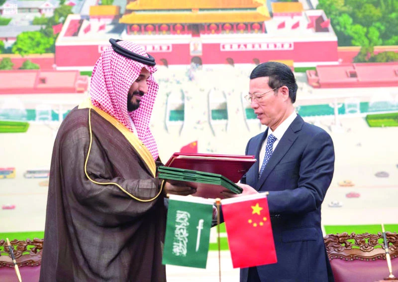 Deputy Crown Prince Mohammed bin Salman exchanges documents with Chinese Vice Premier Zhang Gaoli in Beijing on Tuesday. (SPA)