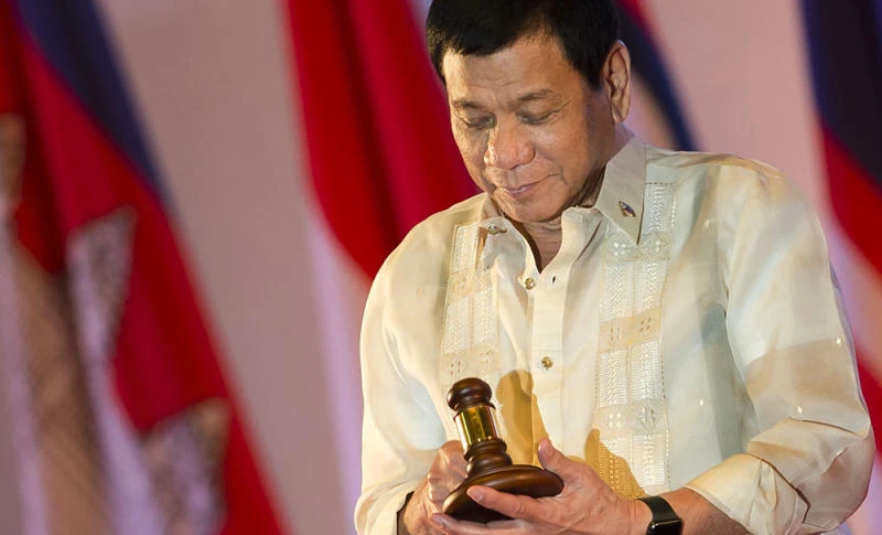 Philippine President Rodrigo Duterte holds the gavel during the closing ceremony of the Association of Southeast Asian Nations (ASEAN) and handover of the ASEAN chairmanship to the Philippines in Vientiane on Thursday. ( AFP / YE AUNG THU)