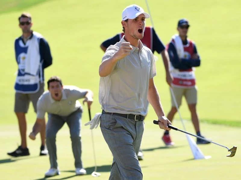 YESSS!: Thomas Pieters of Europe reacts after a putt on the 16th green to win the match as Rory McIlroy looks on during morning foursome matches of the 2016 Ryder Cup at Hazeltine National Golf Club on Saturday in Chaska, Minnesota. (AFP)