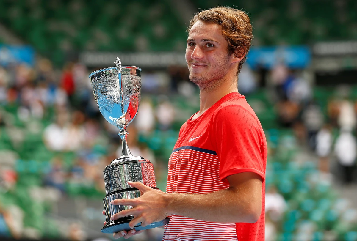 Australia's Oliver Anderson with his trophy after winning his Junior Boys' Singles final match at Melbourne Park on Jan. 30, 2016. (Reuters)