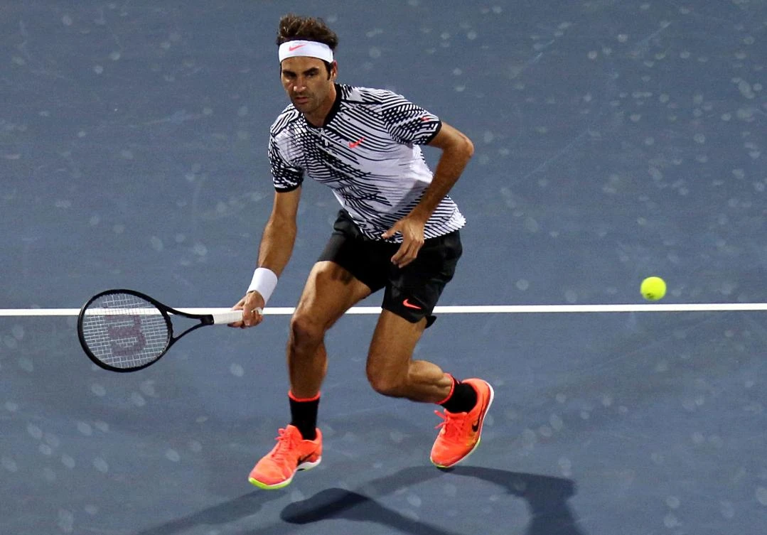 Roger Federer returns the ball to Benoit Paire during their ATP tennis match as part of the Dubai Duty Free Championships on Monday. (AFP)